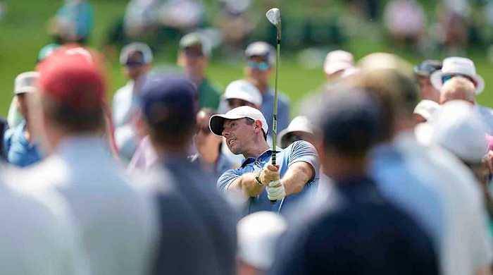 Rory McIlroy hits a shot during practice for the 2023 Masters.